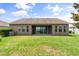 Expansive backyard features lush green grass, perfect for outdoor entertaining or relaxing by the water at 259 Blue Cypress Dr, Groveland, FL 34736