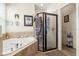 Bathroom features a soaking tub and a glass enclosed shower at 259 Blue Cypress Dr, Groveland, FL 34736