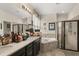 Luxurious bathroom featuring a soaking tub, a glass-enclosed shower, and dual vanities with ample counter space at 259 Blue Cypress Dr, Groveland, FL 34736