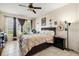 Spacious bedroom with tile floors features a ceiling fan, large windows and a comfortable bed at 259 Blue Cypress Dr, Groveland, FL 34736