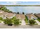 The exterior features a well-maintained lawn and mature trees, showcasing the home's curb appeal and tranquil setting at 259 Blue Cypress Dr, Groveland, FL 34736