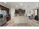 Modern kitchen boasts dark cabinets, stainless steel appliances, a central island, and tile backsplash at 259 Blue Cypress Dr, Groveland, FL 34736