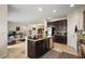 Open-concept kitchen with dark cabinets, stainless steel appliances, a center island, and views to living area at 259 Blue Cypress Dr, Groveland, FL 34736