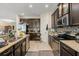 Spacious kitchen features granite counters, stainless appliances, dark cabinets, and tiled backsplash at 259 Blue Cypress Dr, Groveland, FL 34736
