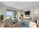 Bright living room with expansive windows overlooking the water, complemented by stylish furniture and modern decor at 259 Blue Cypress Dr, Groveland, FL 34736
