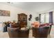 Living room featuring tiled floors, large china cabinet and sitting area by window at 259 Blue Cypress Dr, Groveland, FL 34736