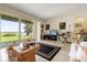 Bright living room with tiled floors and a view of the lake through sliding glass doors at 259 Blue Cypress Dr, Groveland, FL 34736