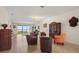 Spacious living room features tile flooring, a decorative cabinet, and views of the lake at 259 Blue Cypress Dr, Groveland, FL 34736