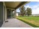Covered patio offers serene views of the lush backyard, screened-in pool, and tranquil lake at 259 Blue Cypress Dr, Groveland, FL 34736