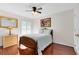 This bedroom features a wooden bedframe, fan with lights, and a window with decorative shutters at 2607 Stanmore Ct, Orlando, FL 32817