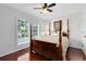Bedroom with beautiful wood floors, large windows, and a four poster bed at 2607 Stanmore Ct, Orlando, FL 32817