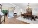 An open-concept home featuring a wood dining table near a curved staircase at 2607 Stanmore Ct, Orlando, FL 32817