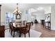 Formal dining area with hardwood floors, a large window and a traditional chandelier at 2607 Stanmore Ct, Orlando, FL 32817