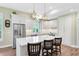 A bright kitchen with white cabinets, stainless steel appliances and an island with chairs at 2607 Stanmore Ct, Orlando, FL 32817