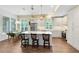 Bright kitchen with white cabinets, stainless steel appliances, island with bar stool seating, and wood floors at 2607 Stanmore Ct, Orlando, FL 32817