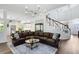 Open living area featuring wood floors and view of the kitchen and staircase at 2607 Stanmore Ct, Orlando, FL 32817