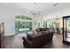 Open-concept living area with wood floors, sliding glass doors, and a view of the kitchen at 2607 Stanmore Ct, Orlando, FL 32817