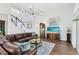 Spacious living room with high ceilings, wood floors, large windows and a staircase in the background at 2607 Stanmore Ct, Orlando, FL 32817