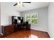This office features a wooden desk, chair, and a window with decorative shutters to allow natural light at 2607 Stanmore Ct, Orlando, FL 32817