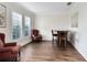 Cozy sitting room featuring wood floors, plantation shutters, and comfortable seating at 2607 Stanmore Ct, Orlando, FL 32817