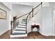 Bright foyer with a curved staircase featuring dark wood treads and white risers and banister at 2607 Stanmore Ct, Orlando, FL 32817