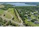 Expansive aerial view showcases a lakeside community with lush landscaping and nearby lake access at 2633 Pickett Downs Dr, Chuluota, FL 32766