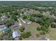 Aerial view of the home nestled among lush trees, highlighting the expansive lot at 2633 Pickett Downs Dr, Chuluota, FL 32766