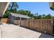 View of fenced-in backyard featuring concrete patio and a small structure at 2633 Pickett Downs Dr, Chuluota, FL 32766