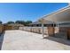 Backyard with a partial view of the house, wooden fence, and concrete patio at 2633 Pickett Downs Dr, Chuluota, FL 32766