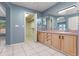 Bathroom with double vanity, walk-in closet, and tile flooring at 2633 Pickett Downs Dr, Chuluota, FL 32766
