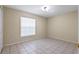 Cozy bedroom featuring tile flooring and a window for natural light at 2633 Pickett Downs Dr, Chuluota, FL 32766