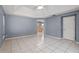 Spacious primary bedroom with tile floors, a vaulted ceiling, and access to kitchen at 2633 Pickett Downs Dr, Chuluota, FL 32766