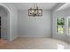 Open dining room with tile flooring, modern light fixture, and natural light at 2633 Pickett Downs Dr, Chuluota, FL 32766