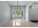 Bright dining room featuring a bay window, stylish lighting, and tile flooring at 2633 Pickett Downs Dr, Chuluota, FL 32766