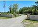Gated entrance with stone pillars and a landscaped sign at 2633 Pickett Downs Dr, Chuluota, FL 32766
