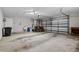 Spacious garage featuring high ceilings and ample room for parking and storage at 2633 Pickett Downs Dr, Chuluota, FL 32766
