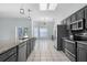 Open kitchen with granite countertops and stainless steel appliances with great natural light at 2633 Pickett Downs Dr, Chuluota, FL 32766