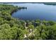Beautiful lake view with mature trees, private beach and dock offering serene waterfront living at 2633 Pickett Downs Dr, Chuluota, FL 32766