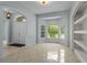 Bright living room featuring a bay window, built-in shelving, and tile flooring at 2633 Pickett Downs Dr, Chuluota, FL 32766
