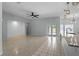 Spacious living room with a modern ceiling fan, granite counters, and tile floors at 2633 Pickett Downs Dr, Chuluota, FL 32766