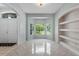 Elegant living room featuring a bay window, built-in shelving, and tile flooring at 2633 Pickett Downs Dr, Chuluota, FL 32766