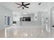 Bright living room features tile floors, modern lighting, and open-concept kitchen at 2633 Pickett Downs Dr, Chuluota, FL 32766