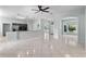Bright living room features tile floors, arched entryways, and open-concept kitchen at 2633 Pickett Downs Dr, Chuluota, FL 32766