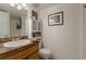 Functional bathroom featuring a vanity, toilet, and built-in storage for toiletries at 2818 Plaza Terrace Dr # 2818, Orlando, FL 32803