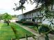 Well-maintained condominium building with a lush green lawn enhancing its curb appeal at 2818 Plaza Terrace Dr # 2818, Orlando, FL 32803