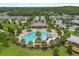 Aerial view of the community pool and recreational area, surrounded by lush landscaping and amenities at 2940 Nottel Dr, St Cloud, FL 34772