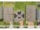 Aerial view of rooftops with solar panels and brick driveways between green lawns at 2940 Nottel Dr, St Cloud, FL 34772