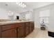 Bathroom featuring double sinks, decorative accents, and a large mirror at 2940 Nottel Dr, St Cloud, FL 34772