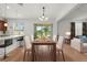 Elegant dining area adjacent to the kitchen, featuring a contemporary chandelier and outdoor views at 2940 Nottel Dr, St Cloud, FL 34772