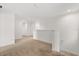 Bright hallway with neutral carpeting and a classic white railing, providing access to the upper-level rooms at 2940 Nottel Dr, St Cloud, FL 34772